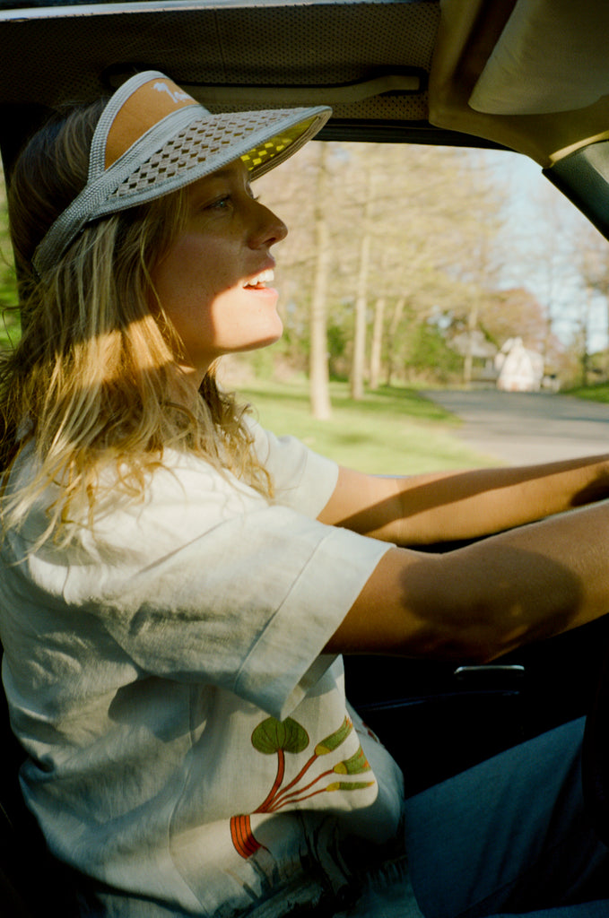 Female model driving a car wearing the visor