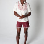 Male model wearing matching set looking right and clasping hands