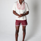 Male model wearing matching set looking right and clasping hands
