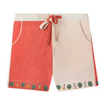 Our playful, color-blocked salmon and light pink shorts, zipped and tied, showcasing small, embroidered agave leaves and tequila bottles on the bottom hem 