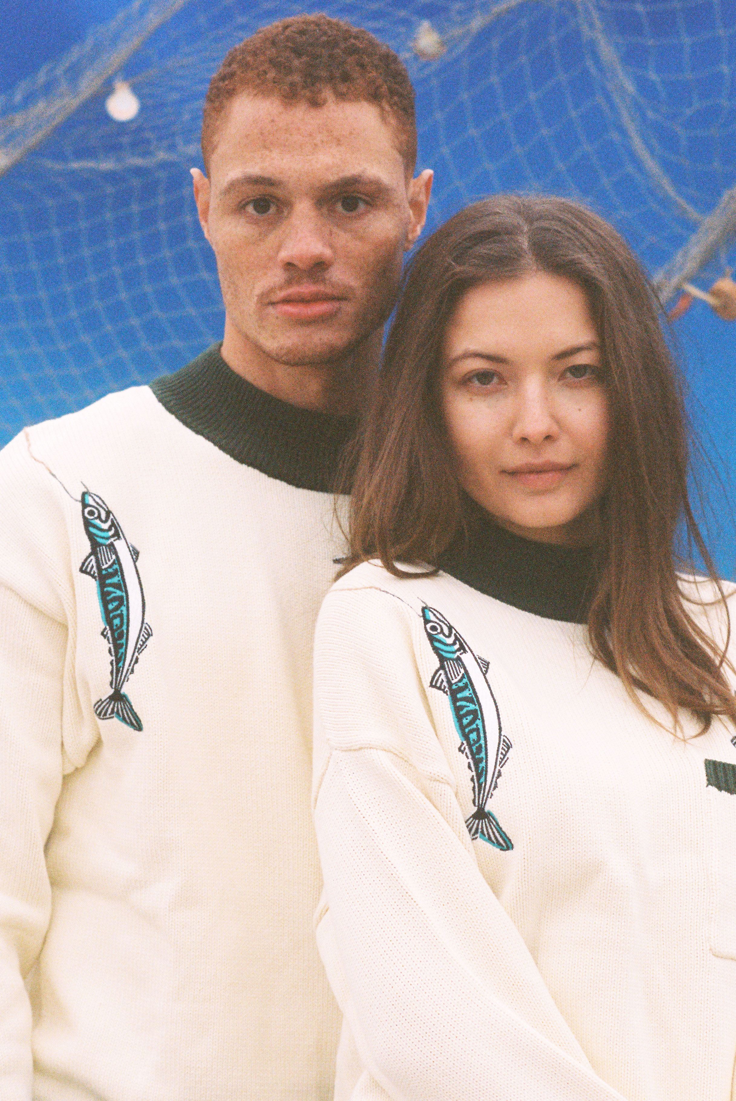Male and female models both wearing the sweater