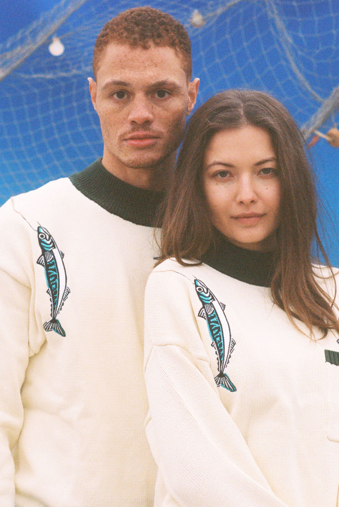 Male and female models both wearing the sweater
