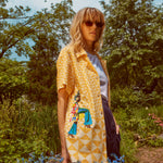 Woman looks at camera wearing sunglasses