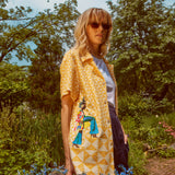 Woman looks at camera wearing sunglasses
