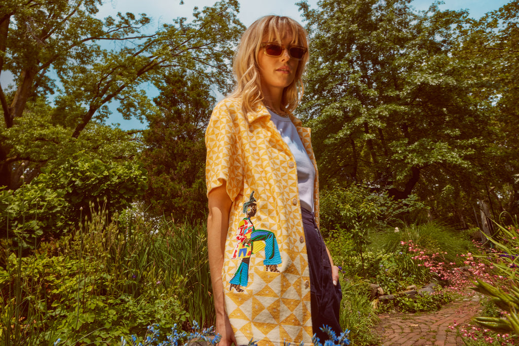 Woman looks at camera wearing sunglasses
