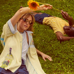 Models lying in field wearing wole shirts