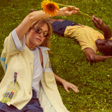Models lying in field wearing wole shirts