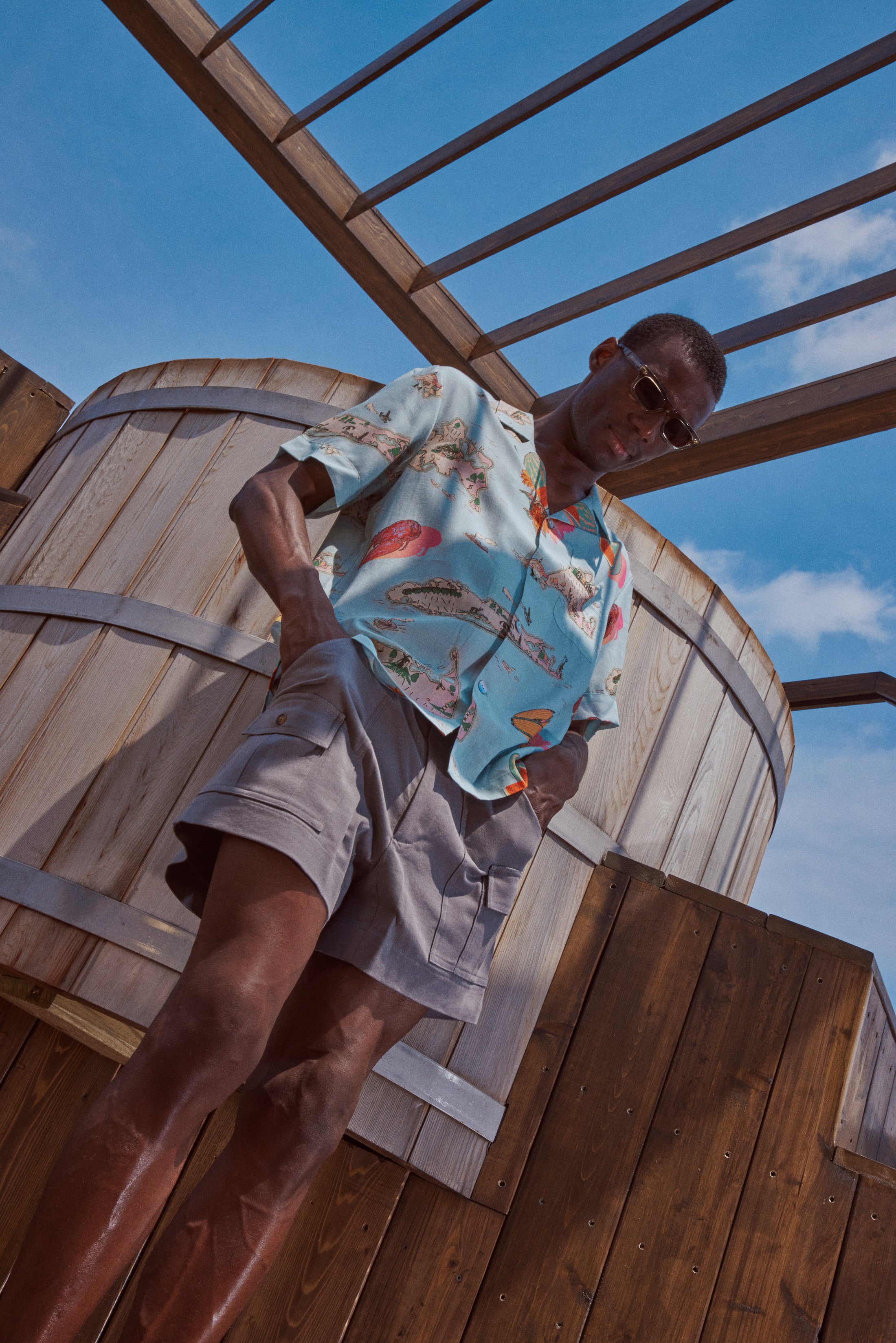 Male model looking down at the ground wearing the top
