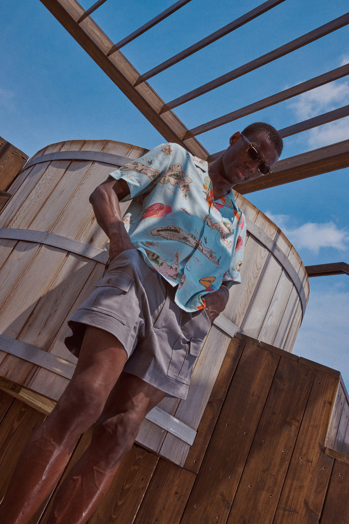 Male model looking down at the ground wearing the top