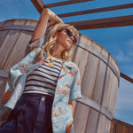 Female model wearing shirt in a picture from a lower angle