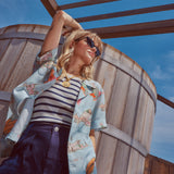 Female model wearing shirt in a picture from a lower angle