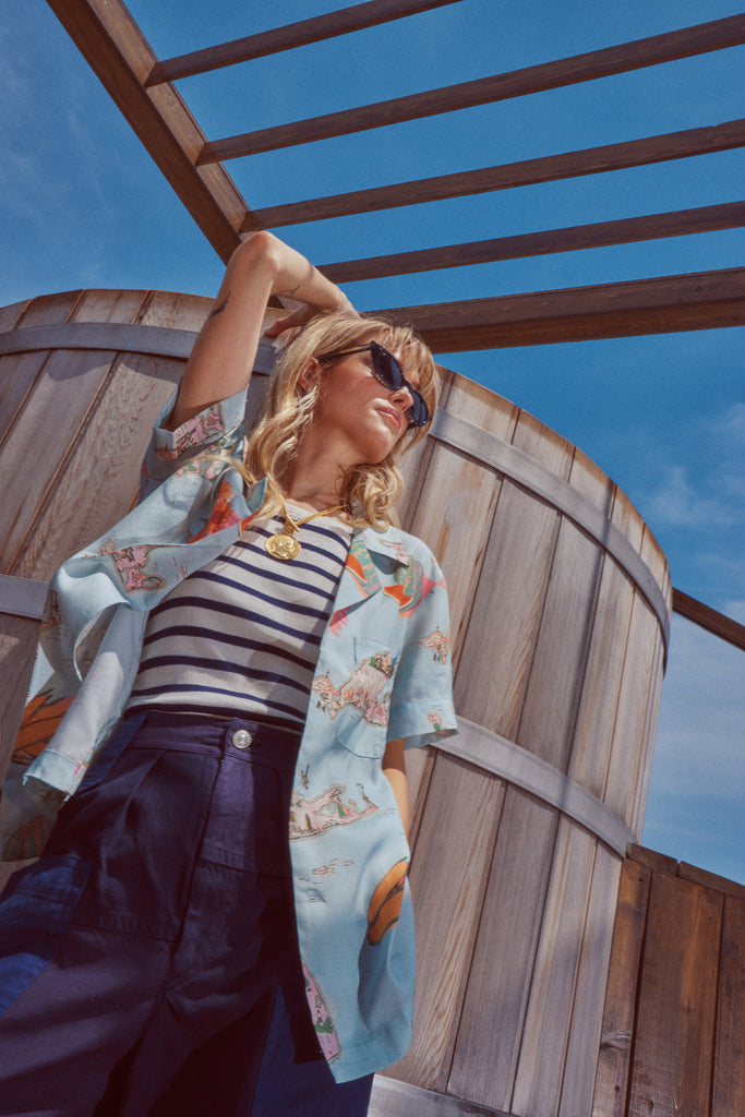 Female model wearing shirt in a picture from a lower angle