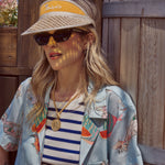Female model wearing the top paired with the yellow tombolo visor