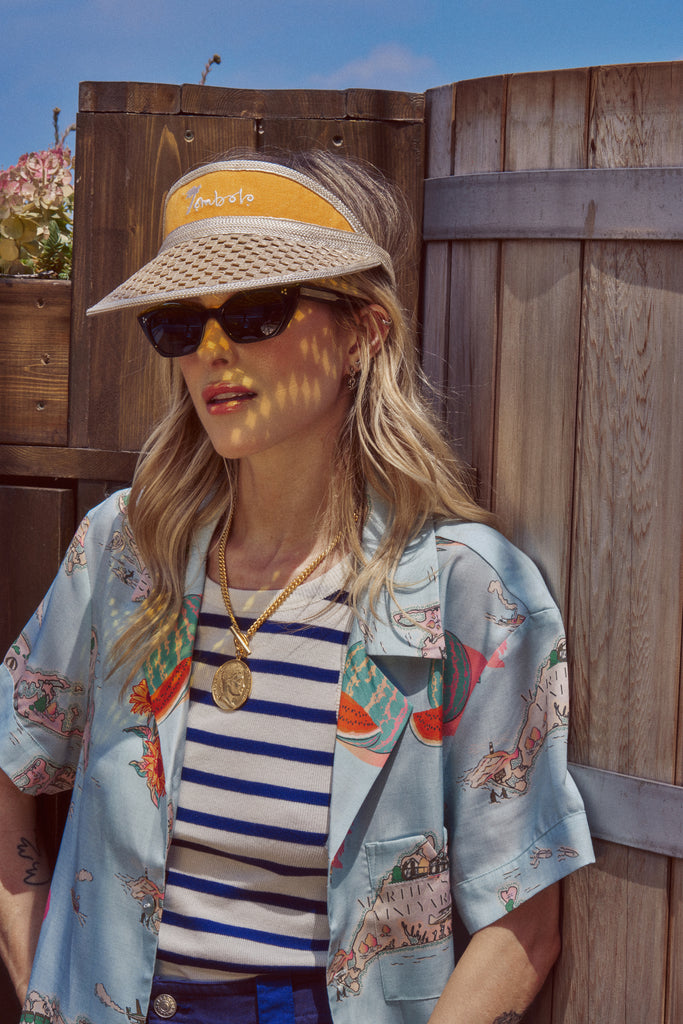 Female model wearing the top paired with the yellow tombolo visor