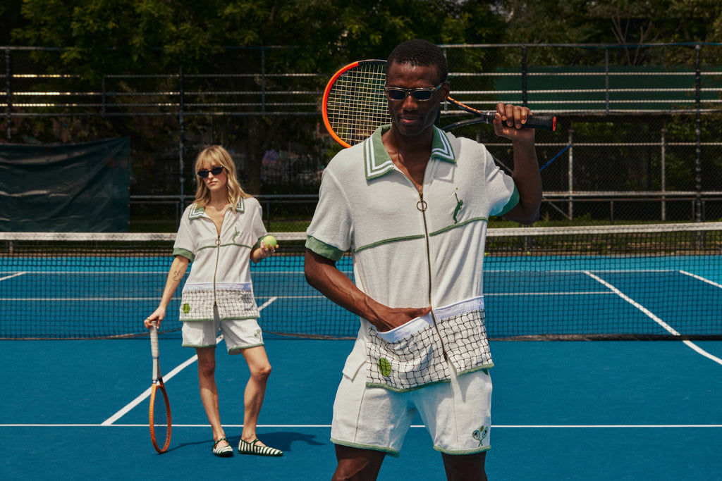 Female and male models both posing in set with tennis balls and rackets