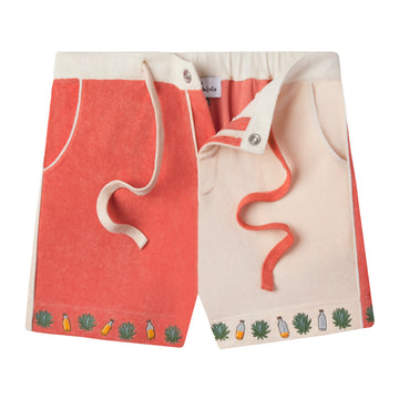 Our playful, color-blocked salmon and light pink shorts, unzipped, showcasing small, embroidered agave leaves and tequila bottles on the bottom hem to match the Tombolo classic cotton terry cloth cabana shirt