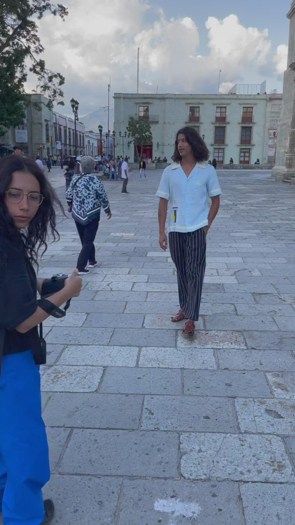 Video of man walking through town wearing baby blue Tombolo Martini shirt