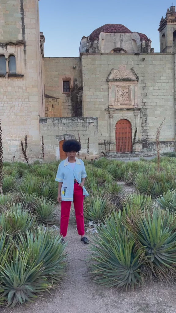 Video of woman wearing oversized Tombolo linen martini shirt walking happily towards camera