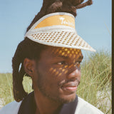 male model in the sun looking right wearing visor