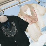 Cloud Grey Fruits de Mer shirt next to the Black fruits de mer shirt