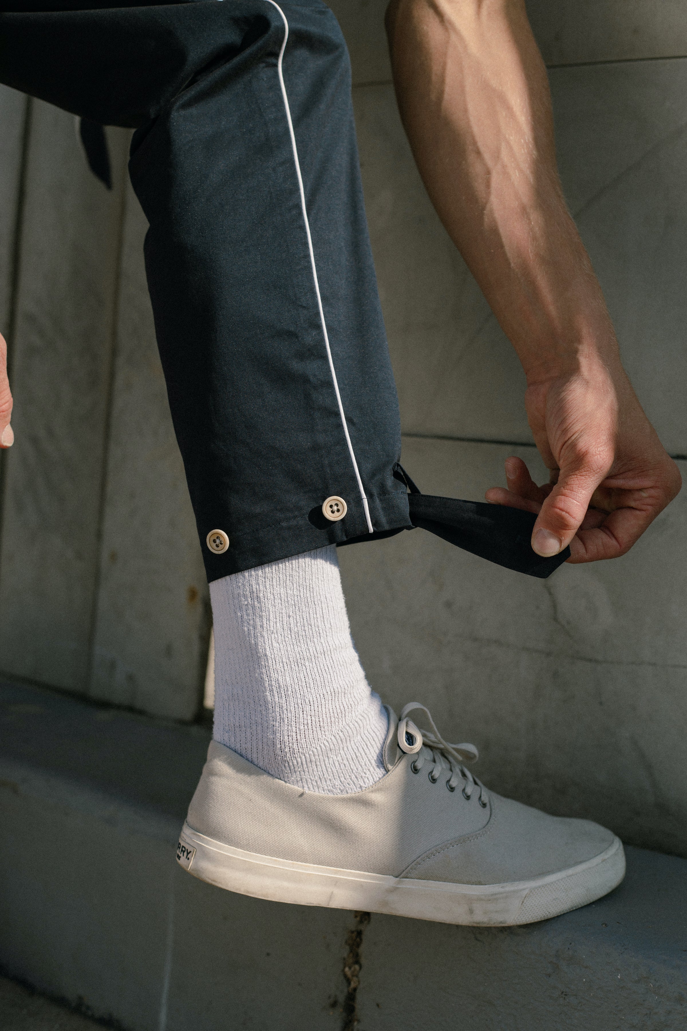 Male model demonstrating the multi button fastenings at the leg opening
