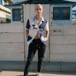 Male model wearing pants with hands in his pockets