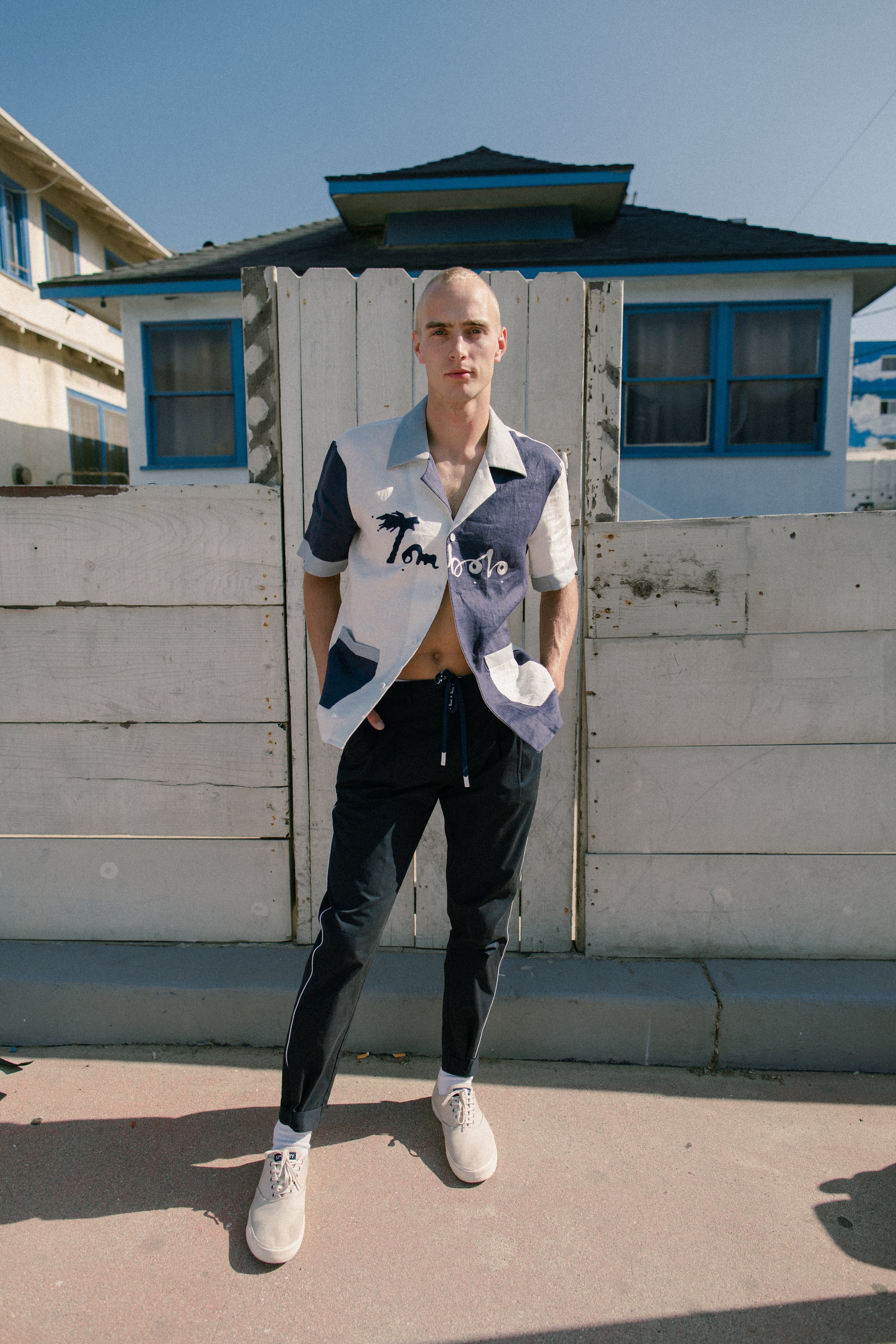 Male model wearing pants with hands in his pockets