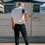 Back view of navy pants on male model