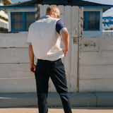 Back view of navy pants on male model