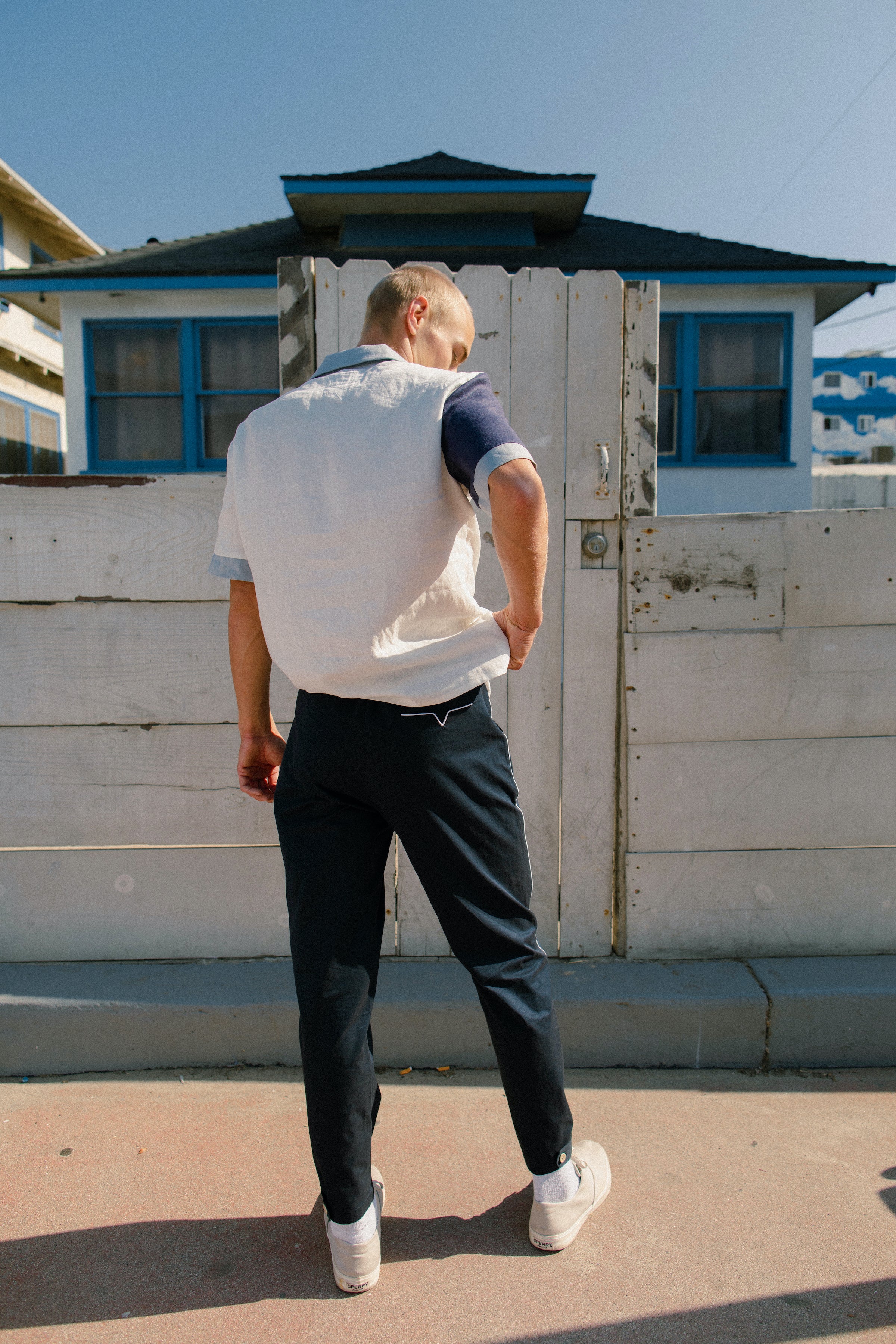 Back view of navy pants on male model