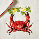 close up of embroidered red crab next to lapel