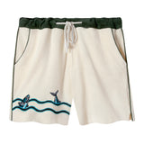 Cream shorts with a forest green waistband and piping, also showing embroidered fish and waves on the lower left leg, complete with a white rope style drawstring