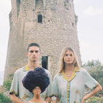 Male and female models wearing the shirt holding a Sandulli coral head statue
