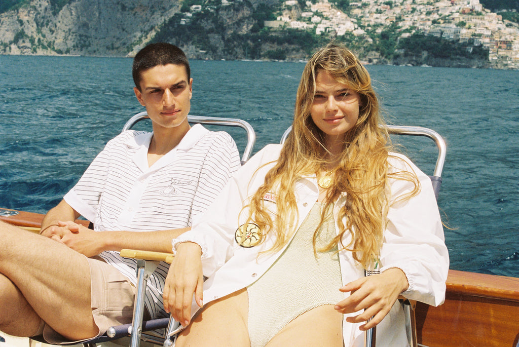 Female model smiling in jacket on the waters of positano italy