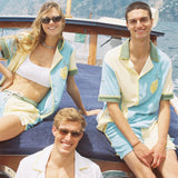 Female model and two male models all in various limoncello sets on boat