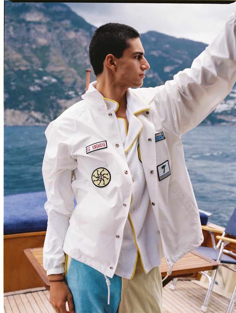 Male model wearing corsa jacket unbuttoned with limoncello shorts