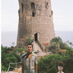 Male model wearing the shirt with shorts and an ascot outdoors