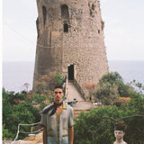 Male model wearing the shirt with shorts and an ascot outdoors