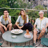 Male and female models sitting next to Paolo Sandulli wearing the shirt
