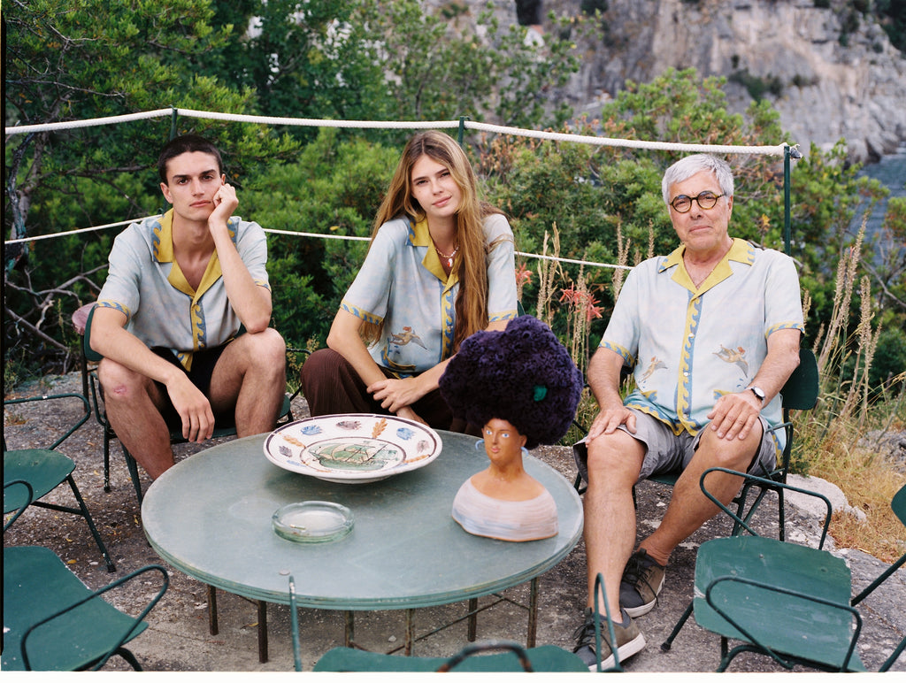Male and female models sitting next to Paolo Sandulli wearing the shirt