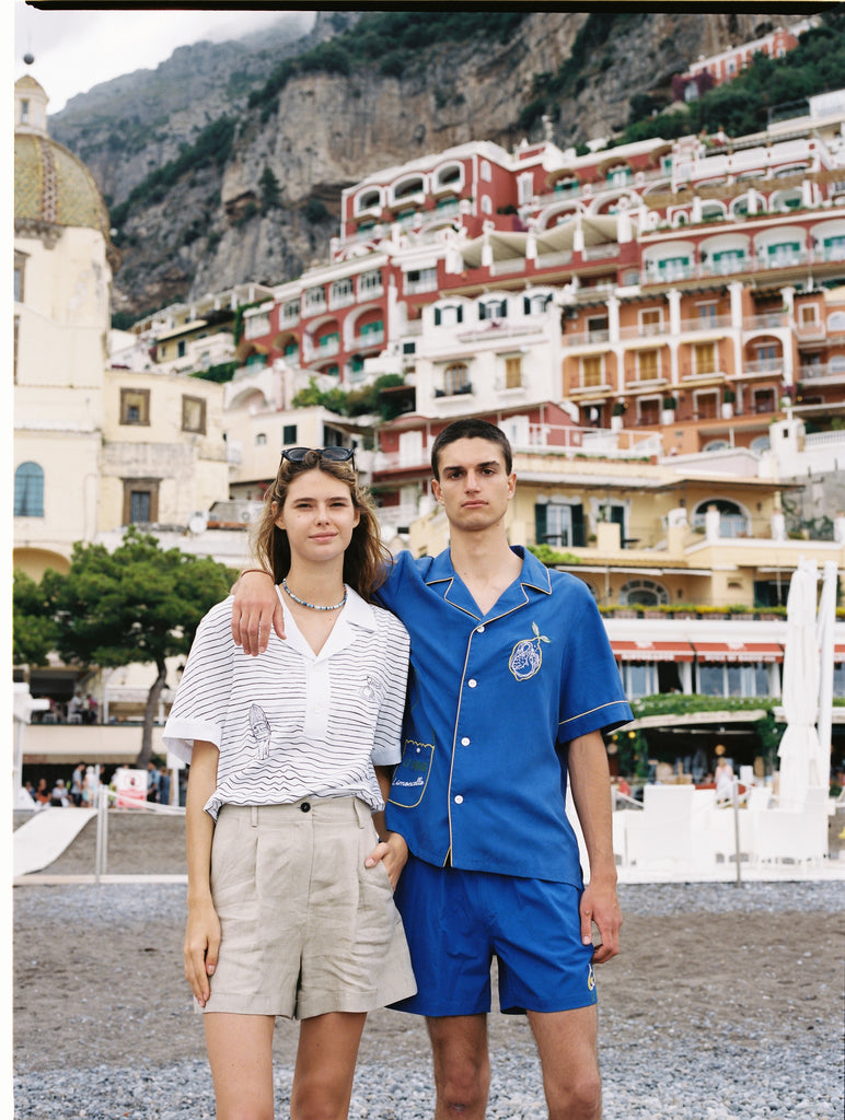 Male model in full limoncello set with arm around female model in positano