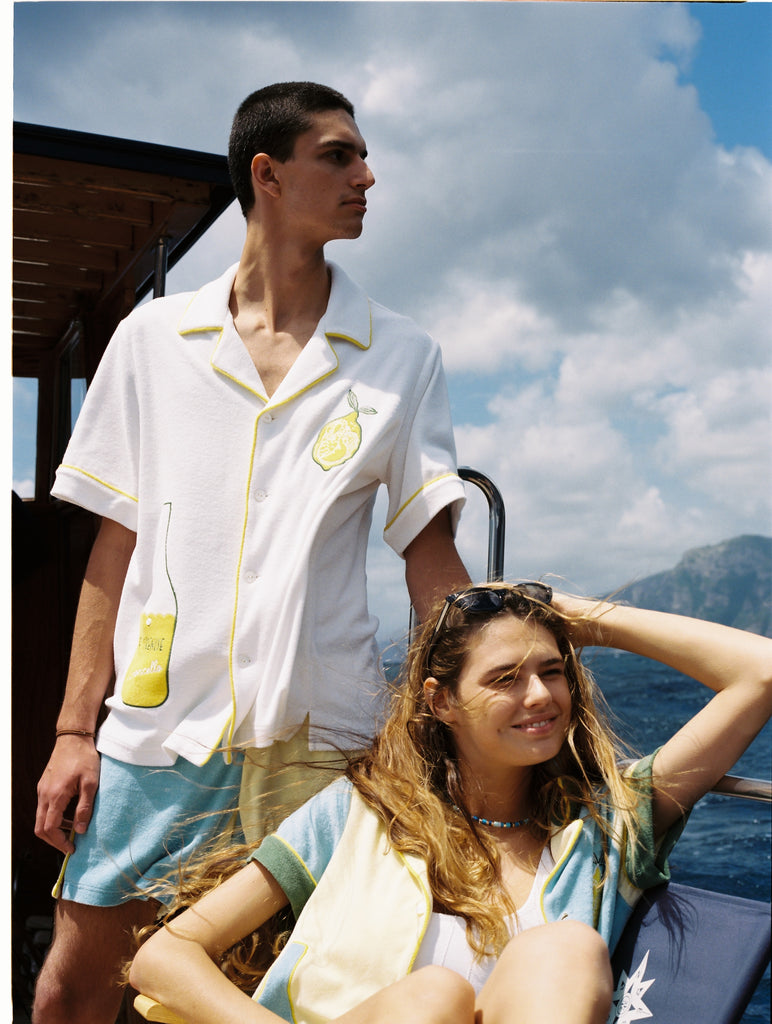 man and woman look off camera towards ocean