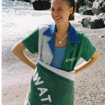 female model wrapped in towel smiling