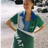 female model wrapped in towel smiling