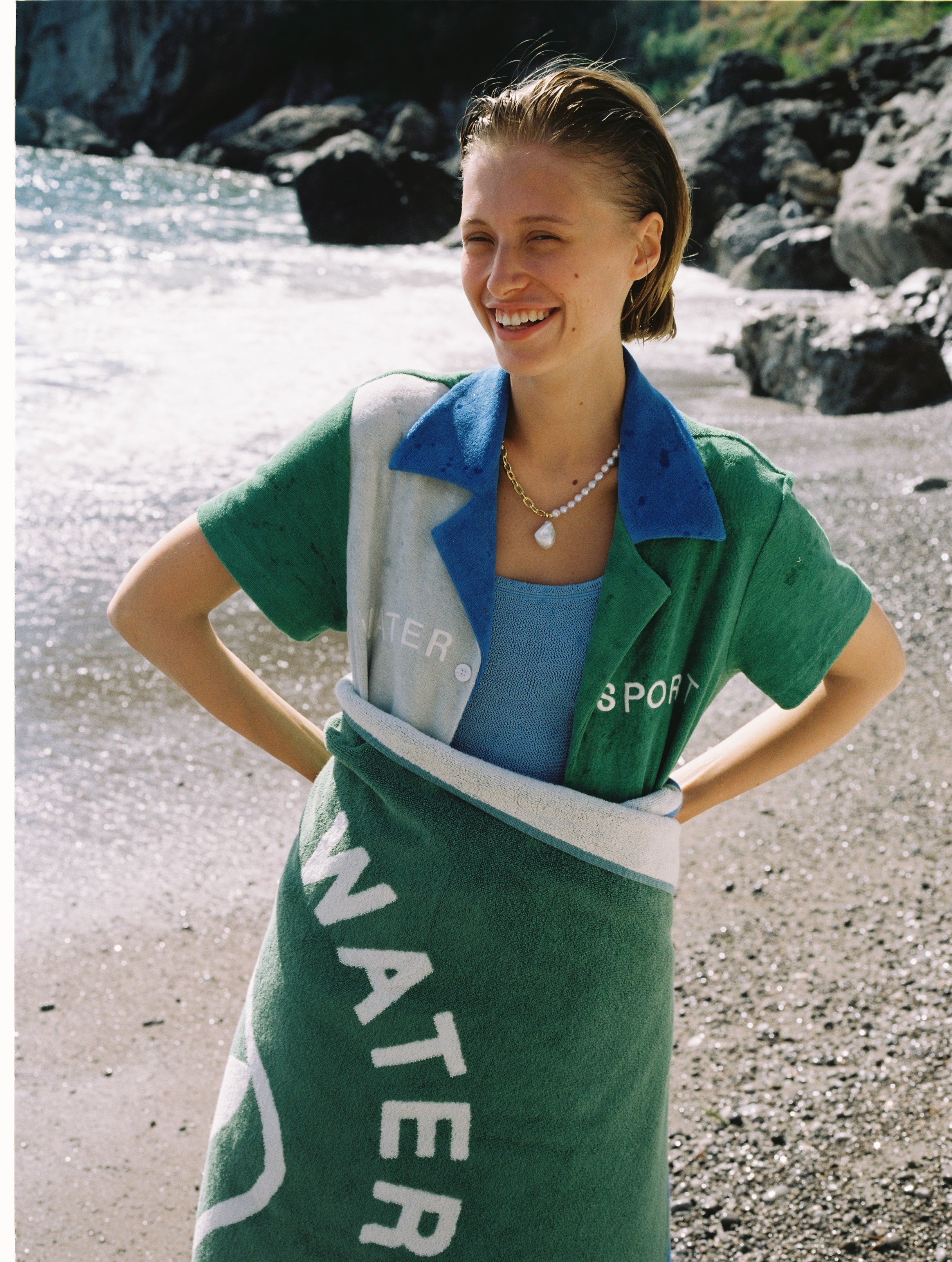 female model wrapped in towel smiling