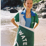 female model wearing water sport towel over her lower half smiling