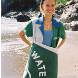 female model wearing water sport towel over her lower half smiling