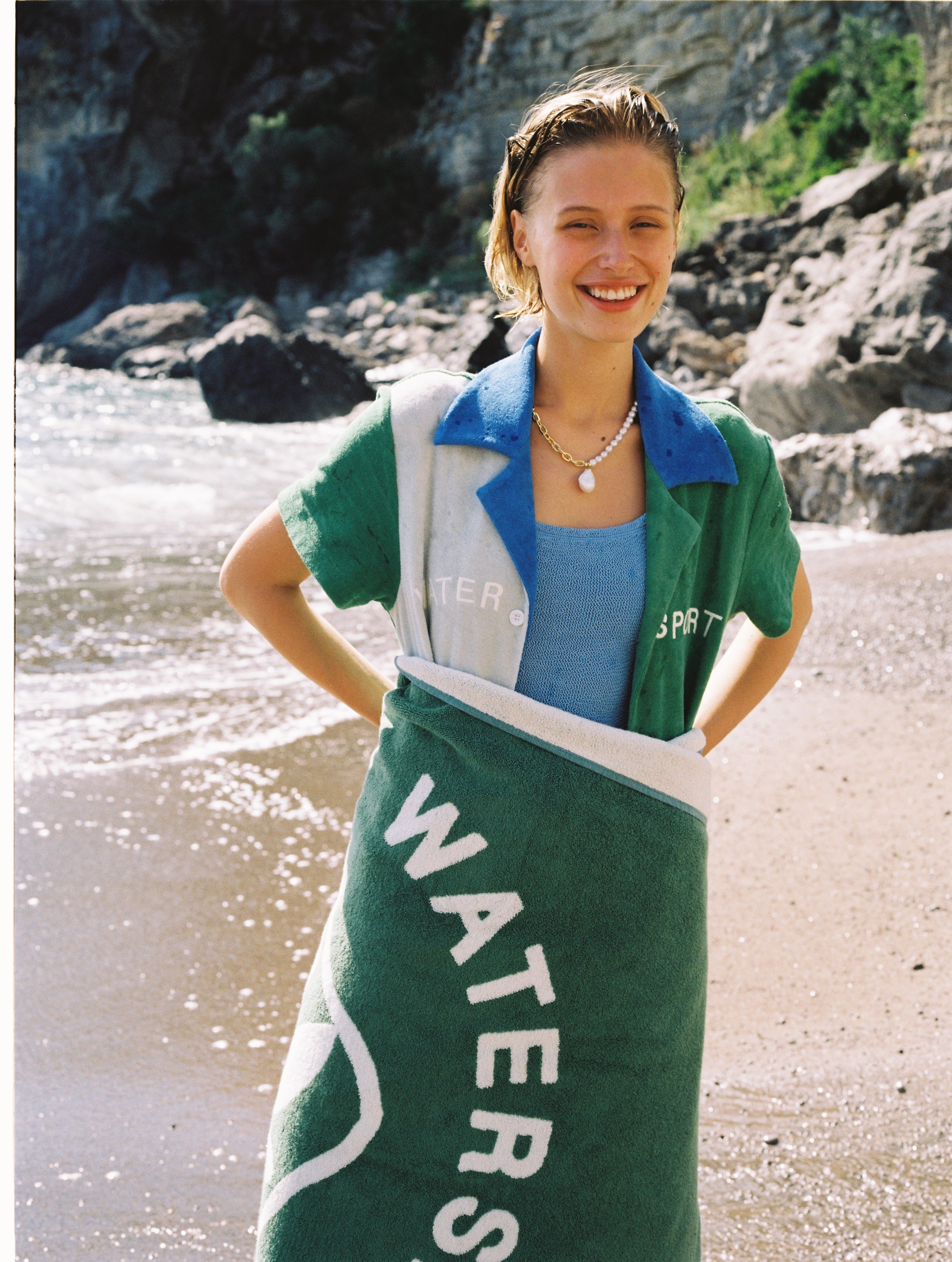 female model wearing water sport towel over her lower half smiling
