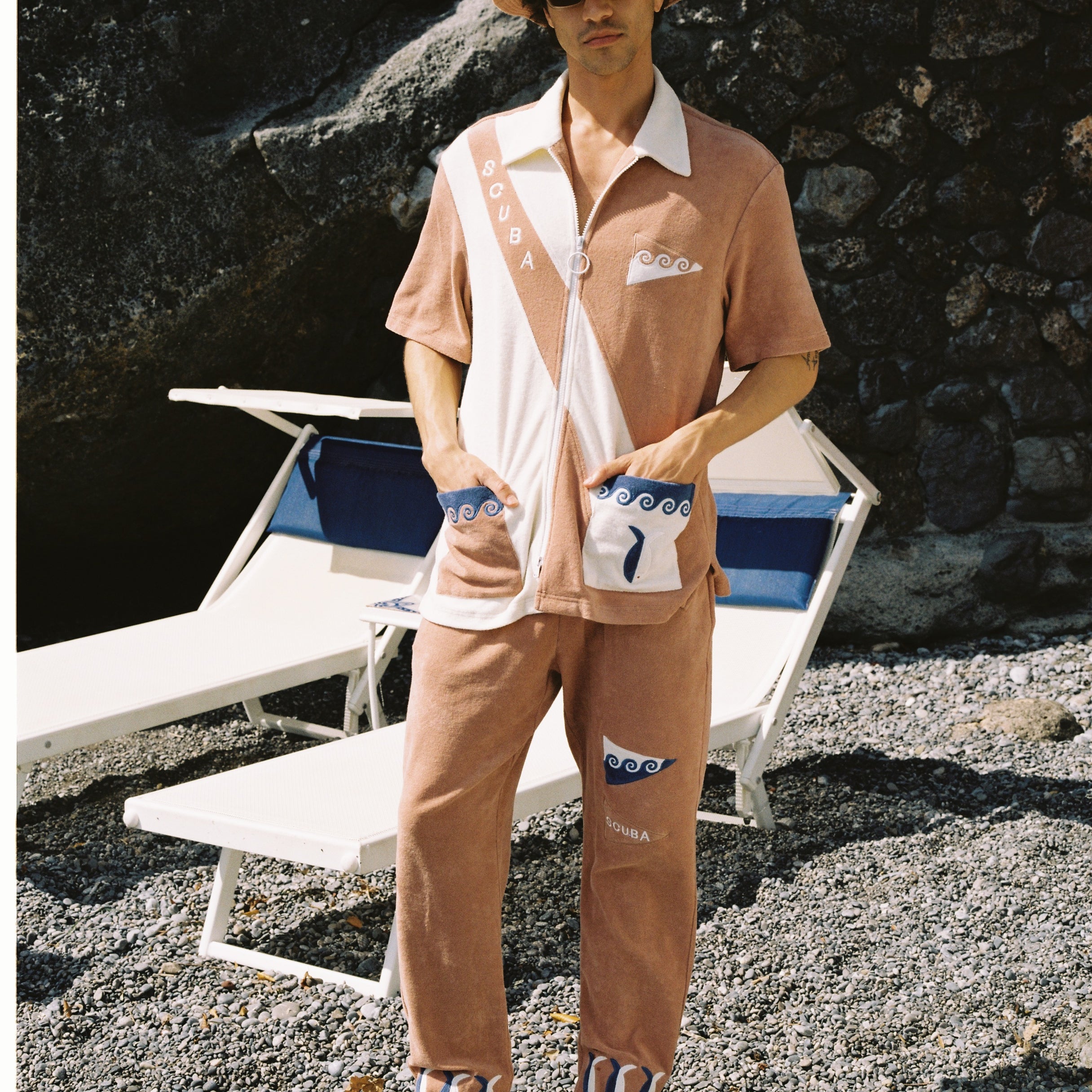 Made from 100% organic cotton terry cloth, this three-piece set boasts waves, fish, and 'SCUBA' embroidery, and comes with matching pants and a bucket hat