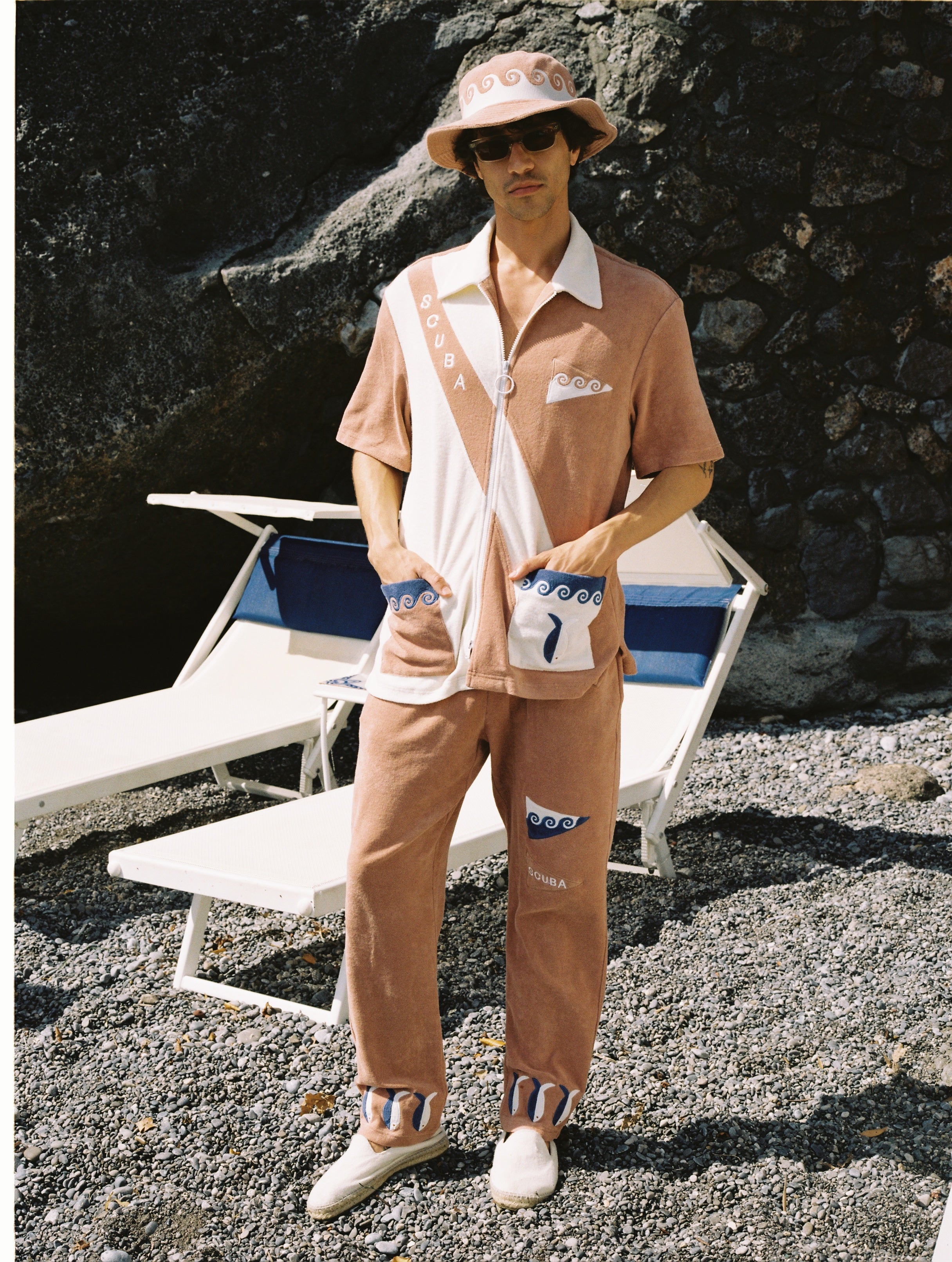 Made from 100% organic cotton terry cloth, this three-piece set boasts waves, fish, and 'SCUBA' embroidery, and comes with matching pants and a bucket hat